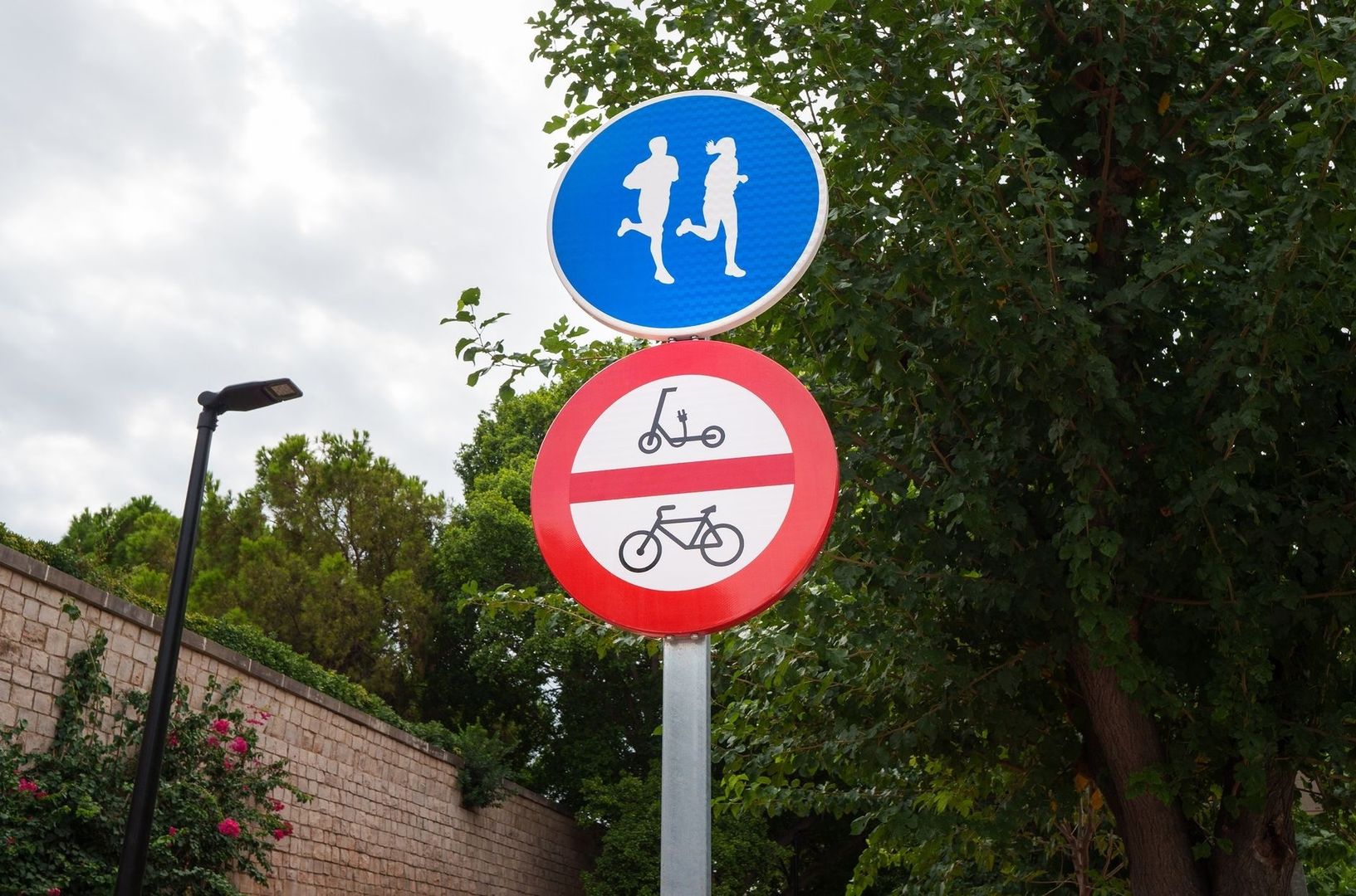 Vägskyltar visar gångväg och förbud mot cyklar och elsparkcyklar